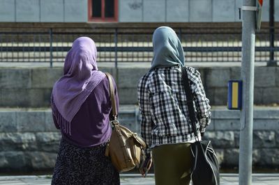 Rear view of women walking on street