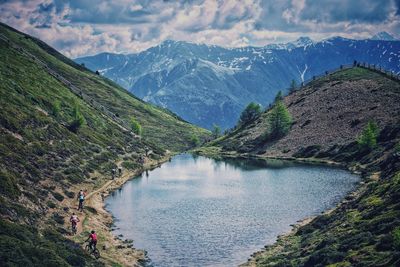 Scenic view of river amidst mountains against sky