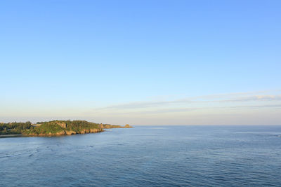 Scenic view of sea against clear blue sky