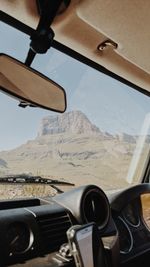 Airplane wing seen through car windshield