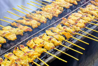 Pork skewers grilled on a stove