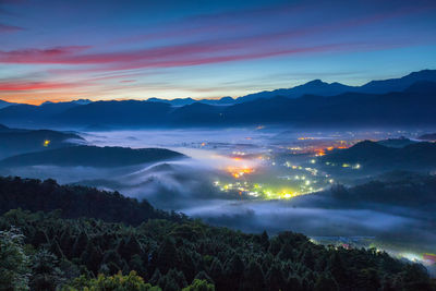 Scenic view of silhouette mountains against blue sky during sunrise