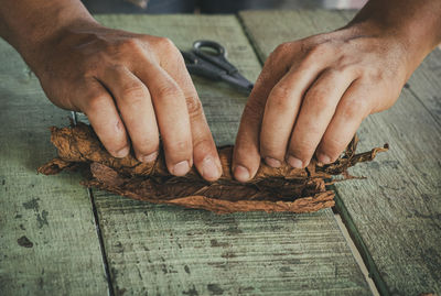 Close-up of man holding ice cream on table