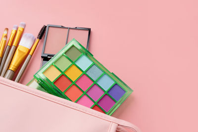 High angle view of books against pink background