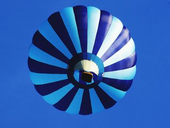 Low angle view of hot air balloon against blue sky