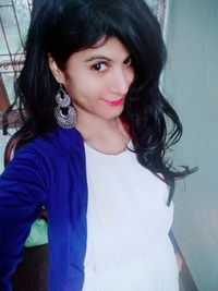 Portrait of beautiful woman standing at home