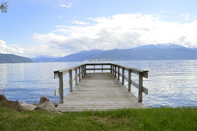 Pier over lake against sky