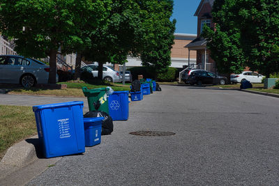 Garbage bin by street in city