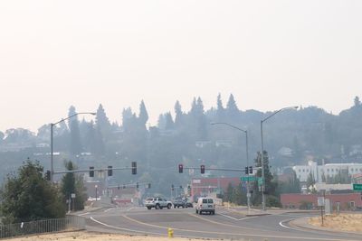 Cars on road in city against clear sky