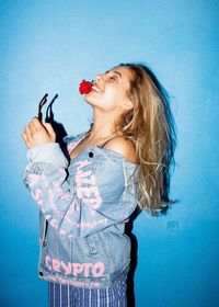 Woman standing against blue background