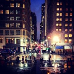 People walking on street in city at night