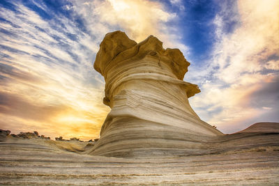 Low angle view of rock formation against sky