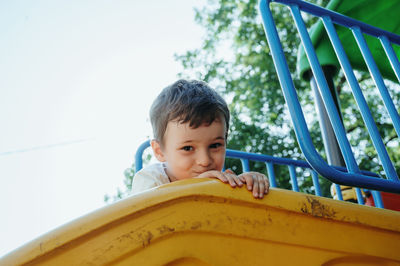 Portrait of boy looking away while standing in playground