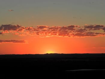 Scenic view of silhouette landscape against romantic sky at sunset