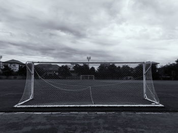 View of soccer field against cloudy sky