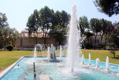 Fountain against trees