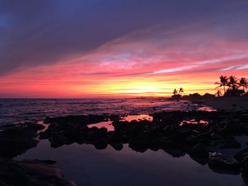 Scenic view of sea against romantic sky at sunset