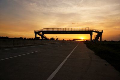 Silhouette bridge against sky during sunset