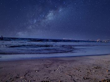 Scenic view of beach against sky at night