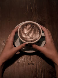 Midsection of person holding coffee cup