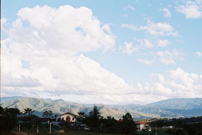 Scenic view of mountains against blue sky