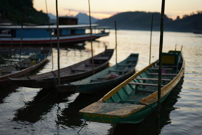 Boats moored on lake against sky
