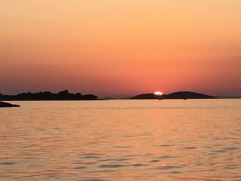 Scenic view of sea against romantic sky at sunset