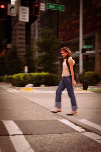 Side view of young woman standing on street