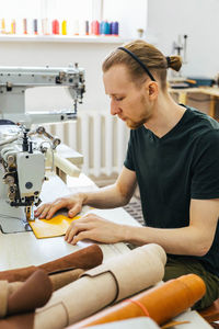 Side view of young man working at home