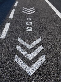 High angle view of arrow symbol on road