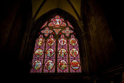 Low angle view of stained glass window in building