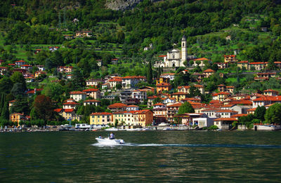 Calm lake with built structures in distance