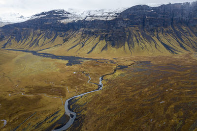 Scenic view of river and mountains against sky