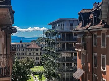 Low angle view of buildings in town against blue sky