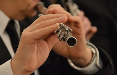 Close-up of man playing flute