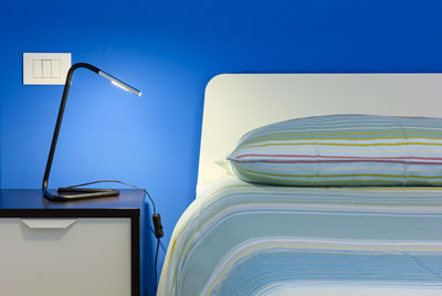 Close-up of objects on table against blue sky