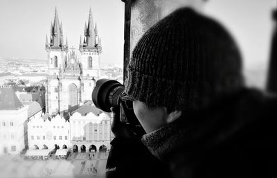 Close-up of man photographing cityscape