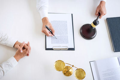 High angle view of man and woman using laptop on table