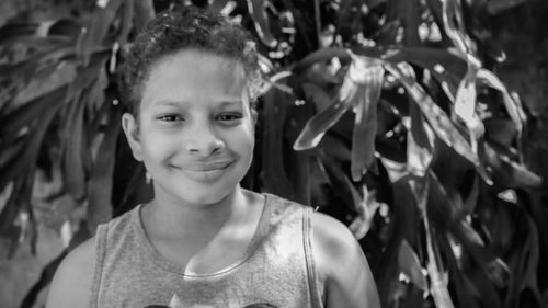 Portrait of smiling boy against plants