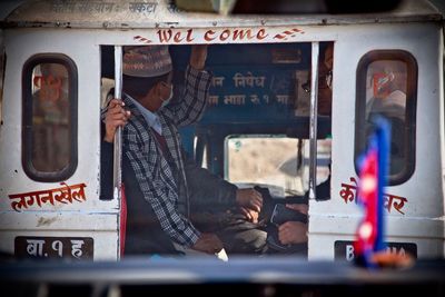 Reflection of man in bus