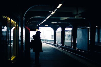 Woman standing at railroad station