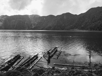 Scenic view of lake by mountains against sky