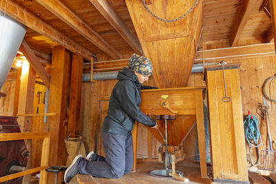 Side view of woman working in flour mill