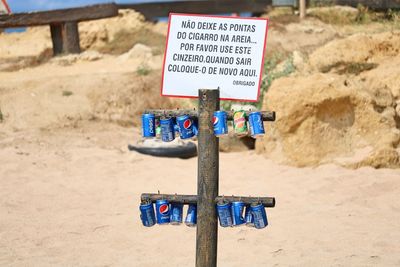 Close-up of information sign on beach