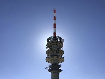 Low angle view of communications tower against sky