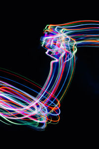 Multi colored light painting against black background