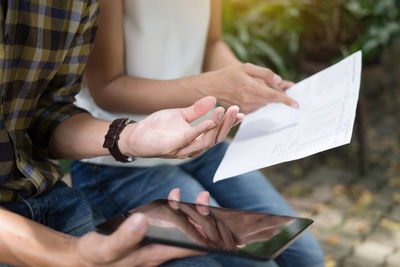 Close-up of hands holding paper