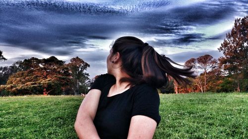 Woman on field against sky