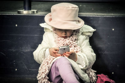 Full length of girl using mobile phone