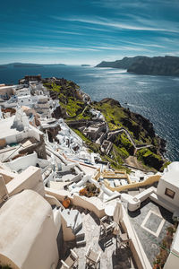 High angle view of buildings by sea against sky